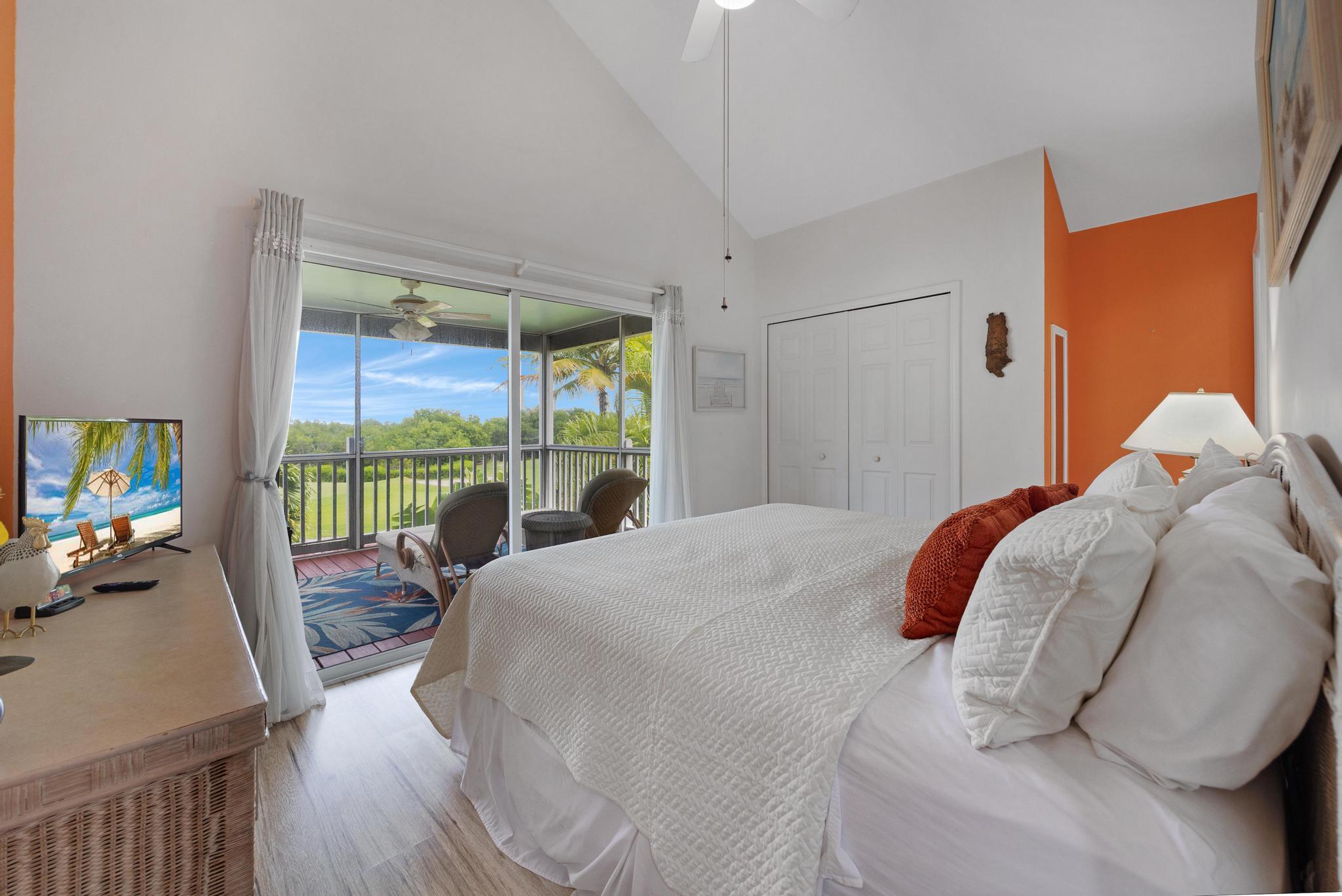 30 Whistling Duck Lane Key West, FL 33040 - Photo 22 of 38 a bedroom with a bed and large windows