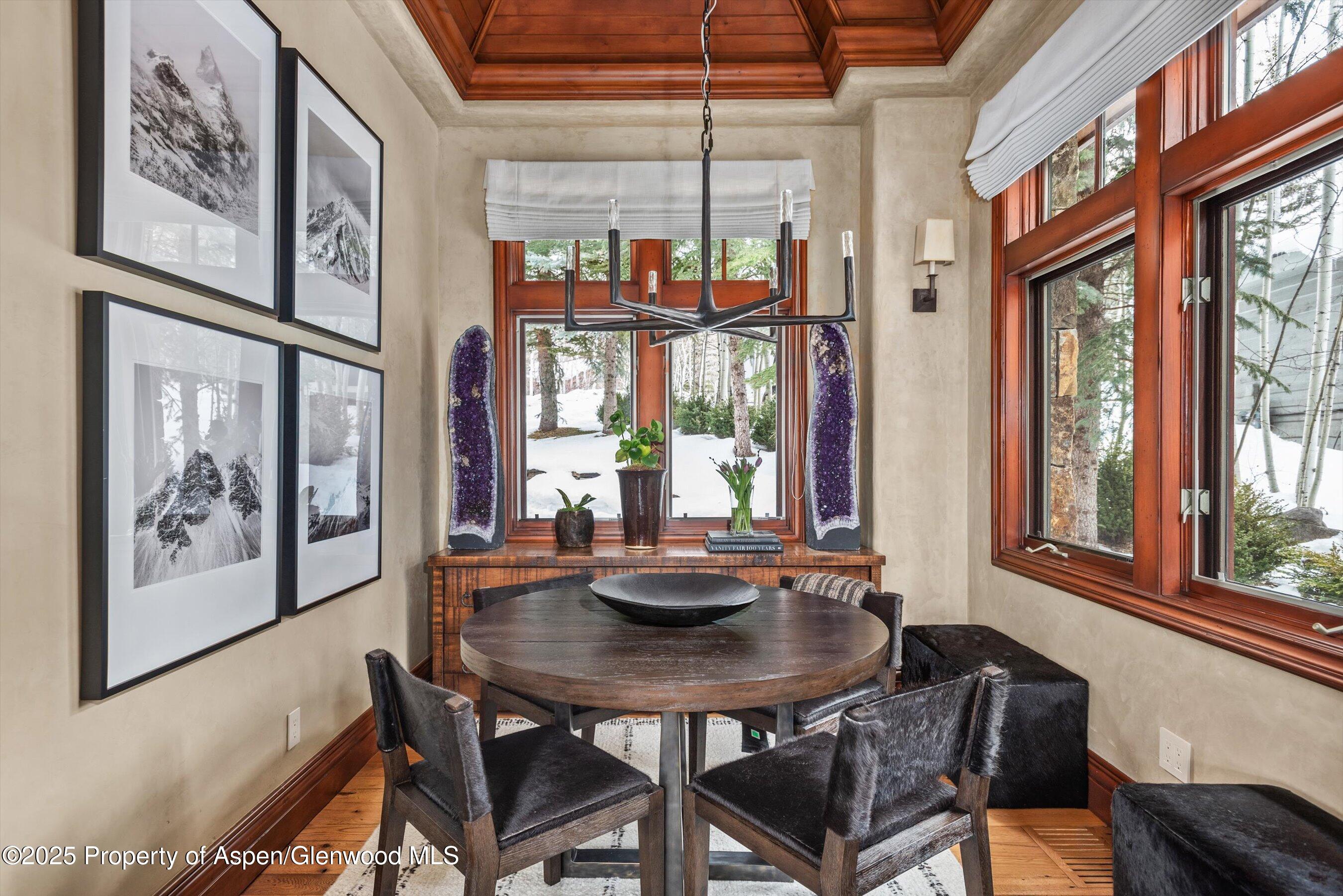 1225 Riverside Drive Aspen, CO 81611 - Photo 13 of 47 a view of a dining room with furniture a chandelier and wooden floor