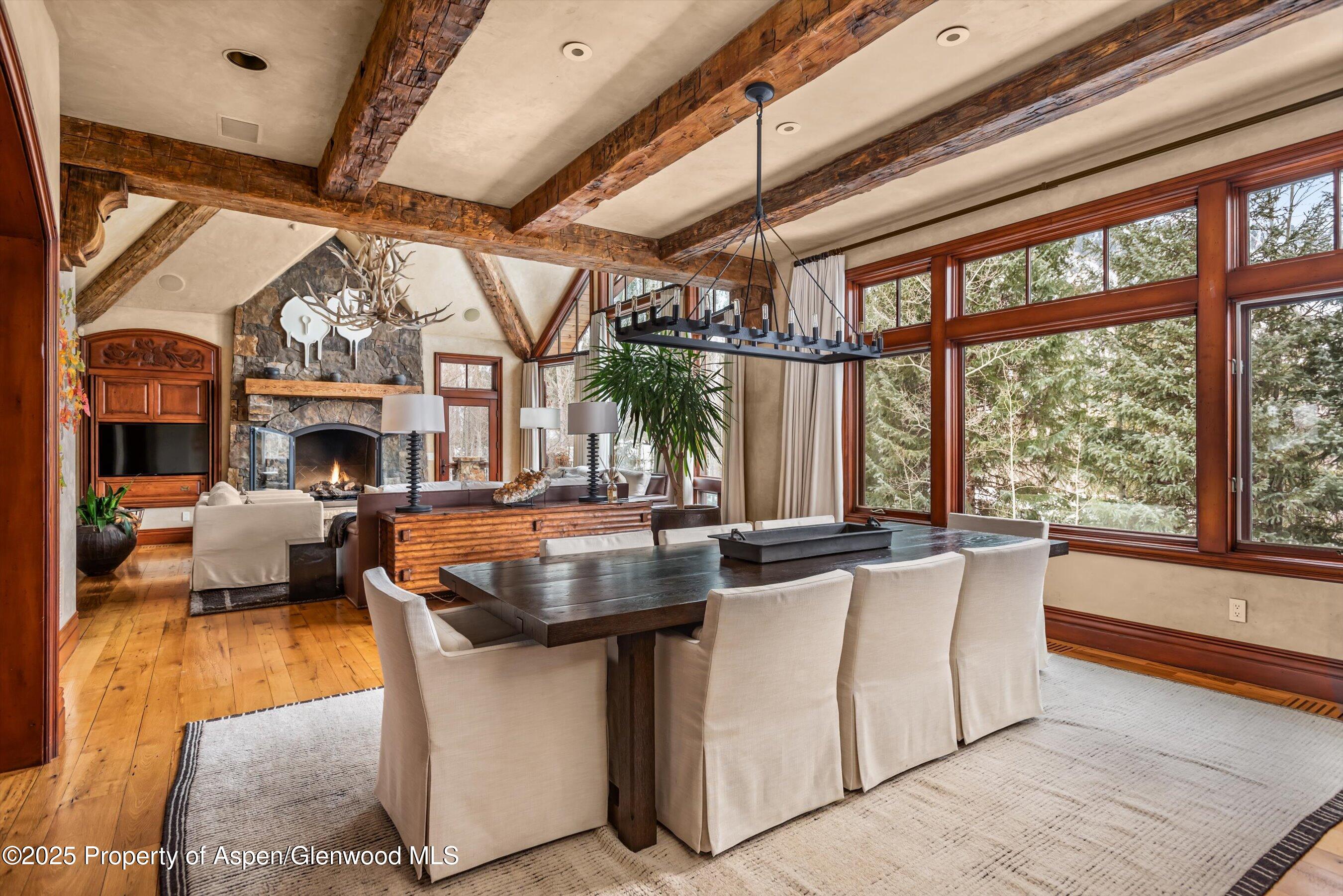 1225 Riverside Drive Aspen, CO 81611 - Photo 16 of 47 a dining room with fireplace furniture and a large window