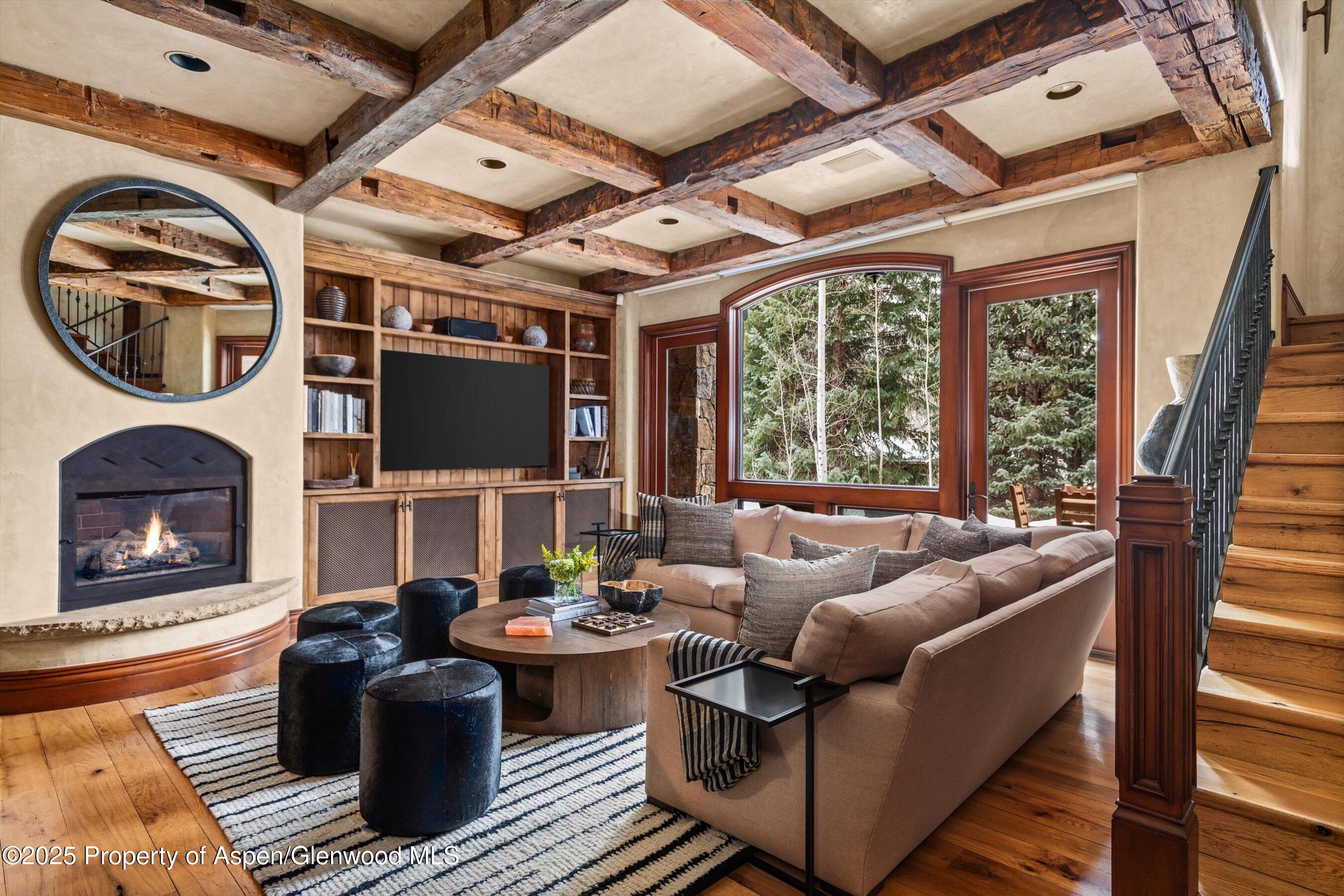 1225 Riverside Drive Aspen, CO 81611 - Photo 21 of 47 a living room with furniture a fireplace and a floor to ceiling window