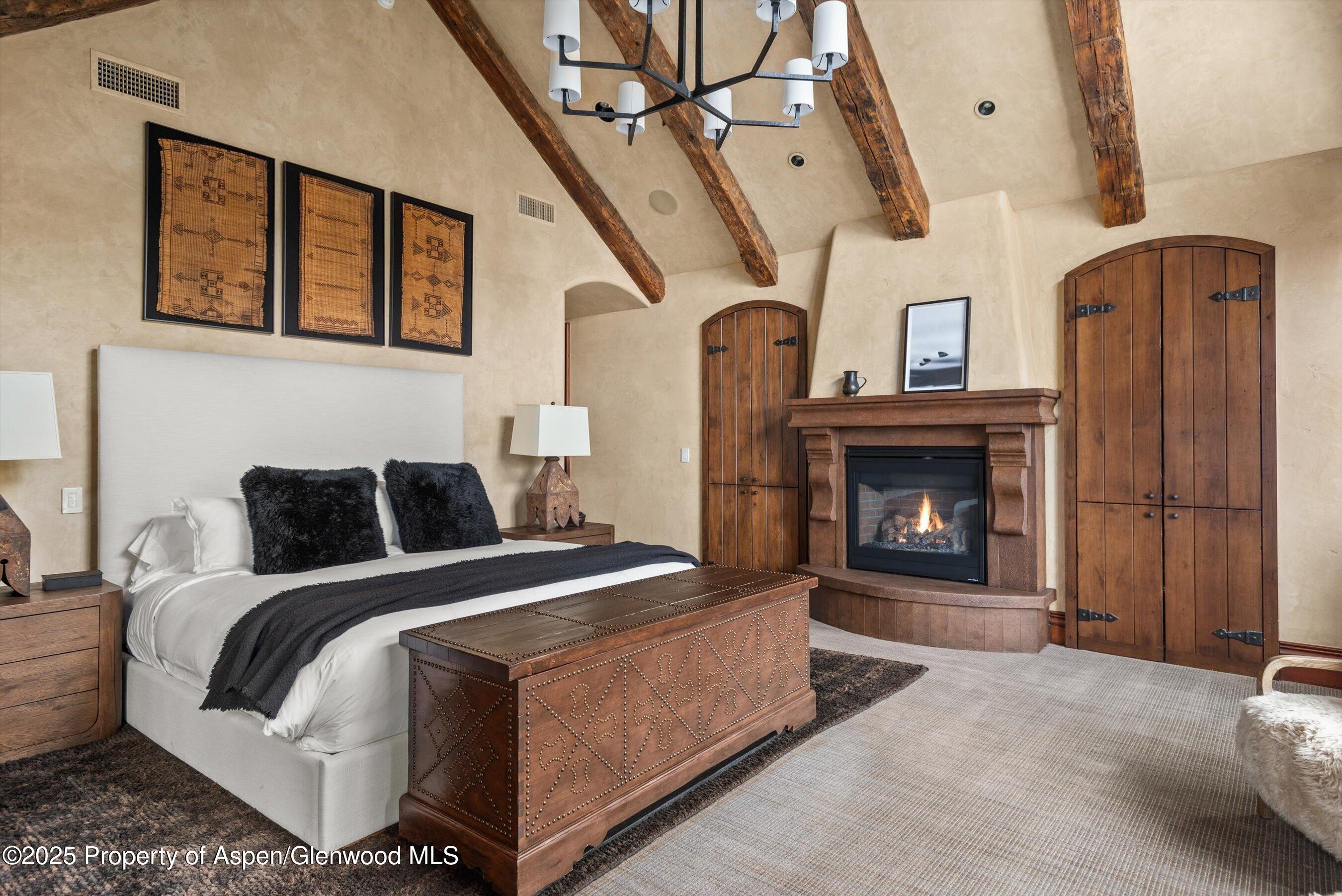 1225 Riverside Drive Aspen, CO 81611 - Photo 28 of 47 a bed room with a bed and a fireplace