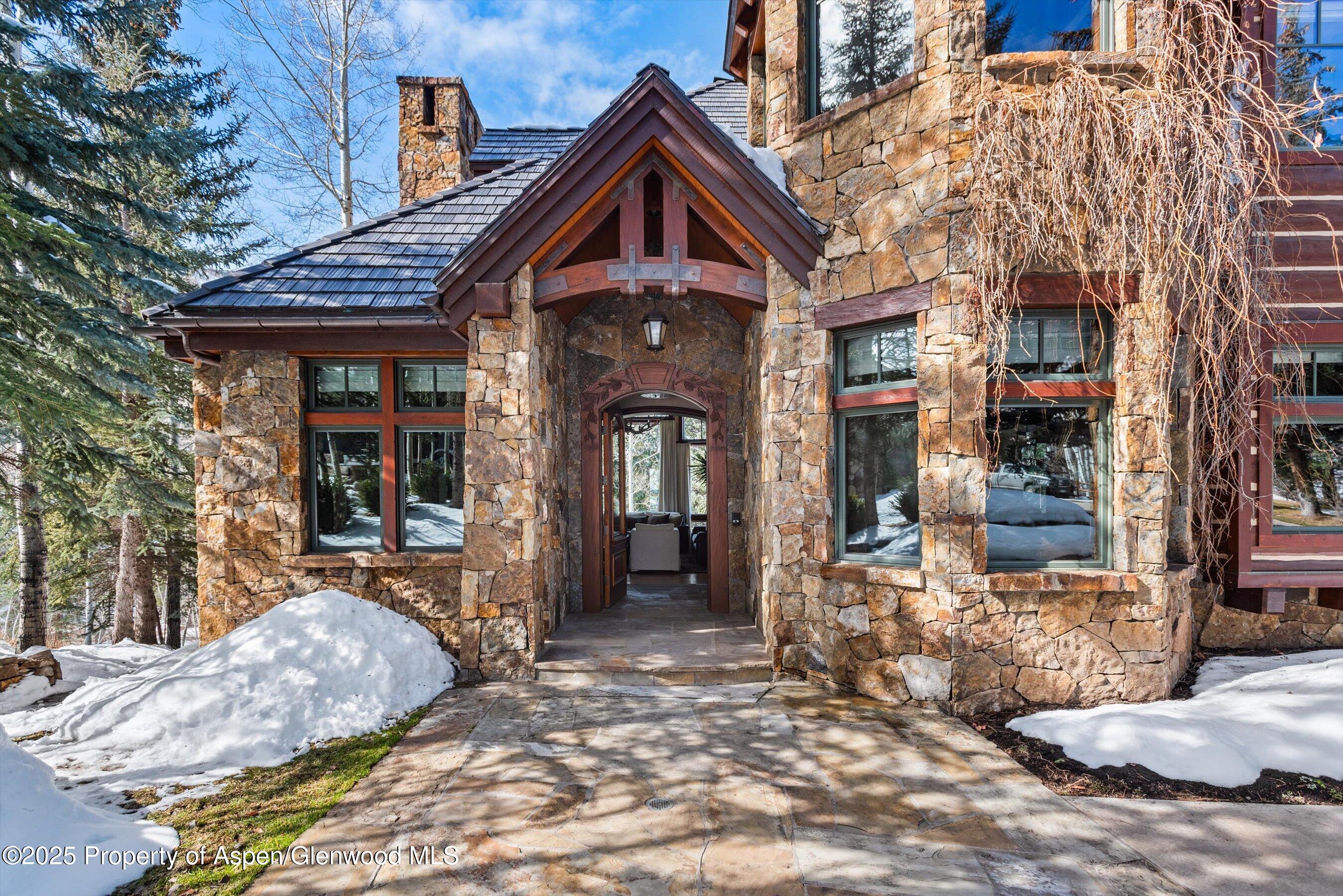 1225 Riverside Drive Aspen, CO 81611 - Photo 3 of 47 a front view of a house with a porch
