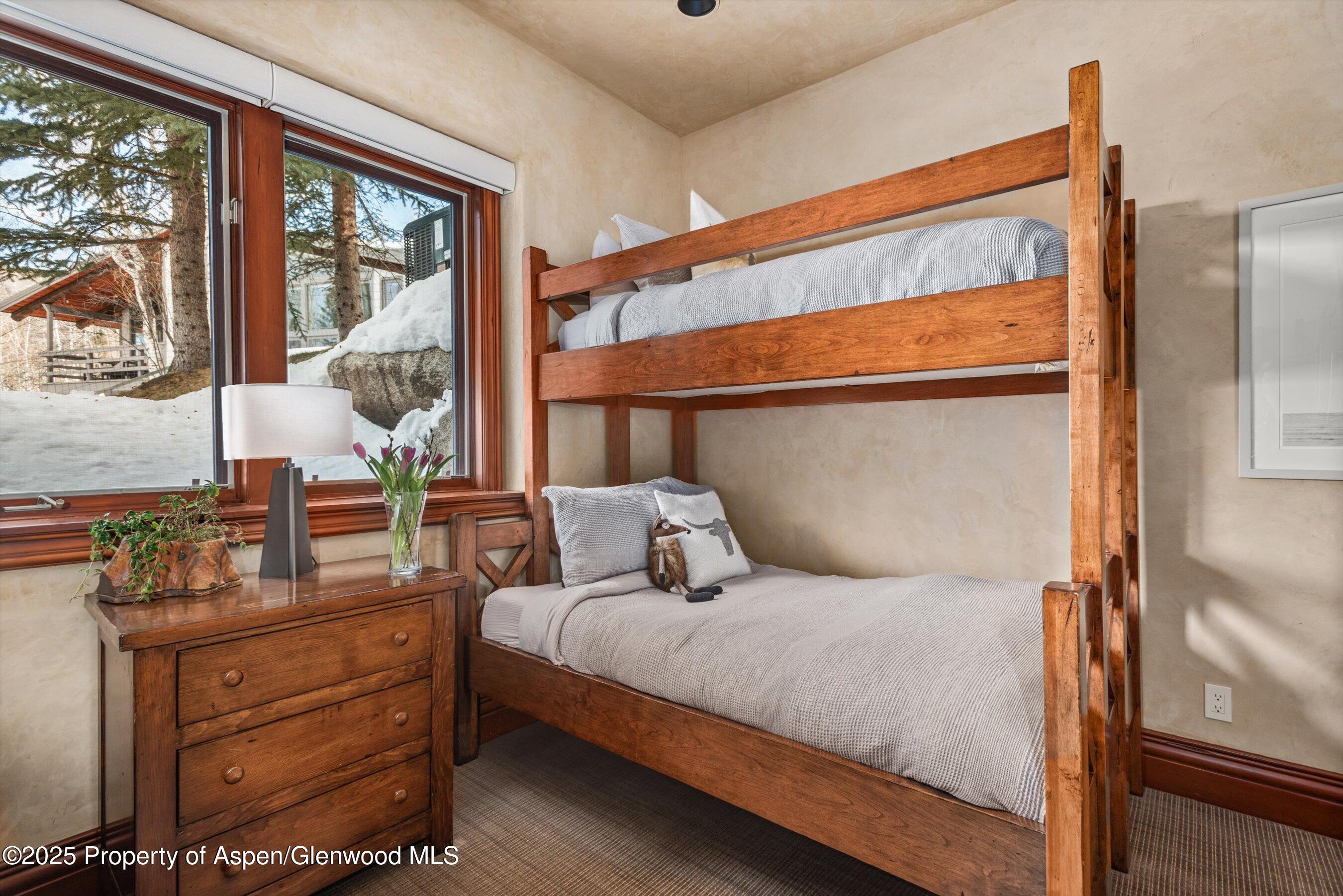 1225 Riverside Drive Aspen, CO 81611 - Photo 38 of 47 a bedroom with a bed and large windows