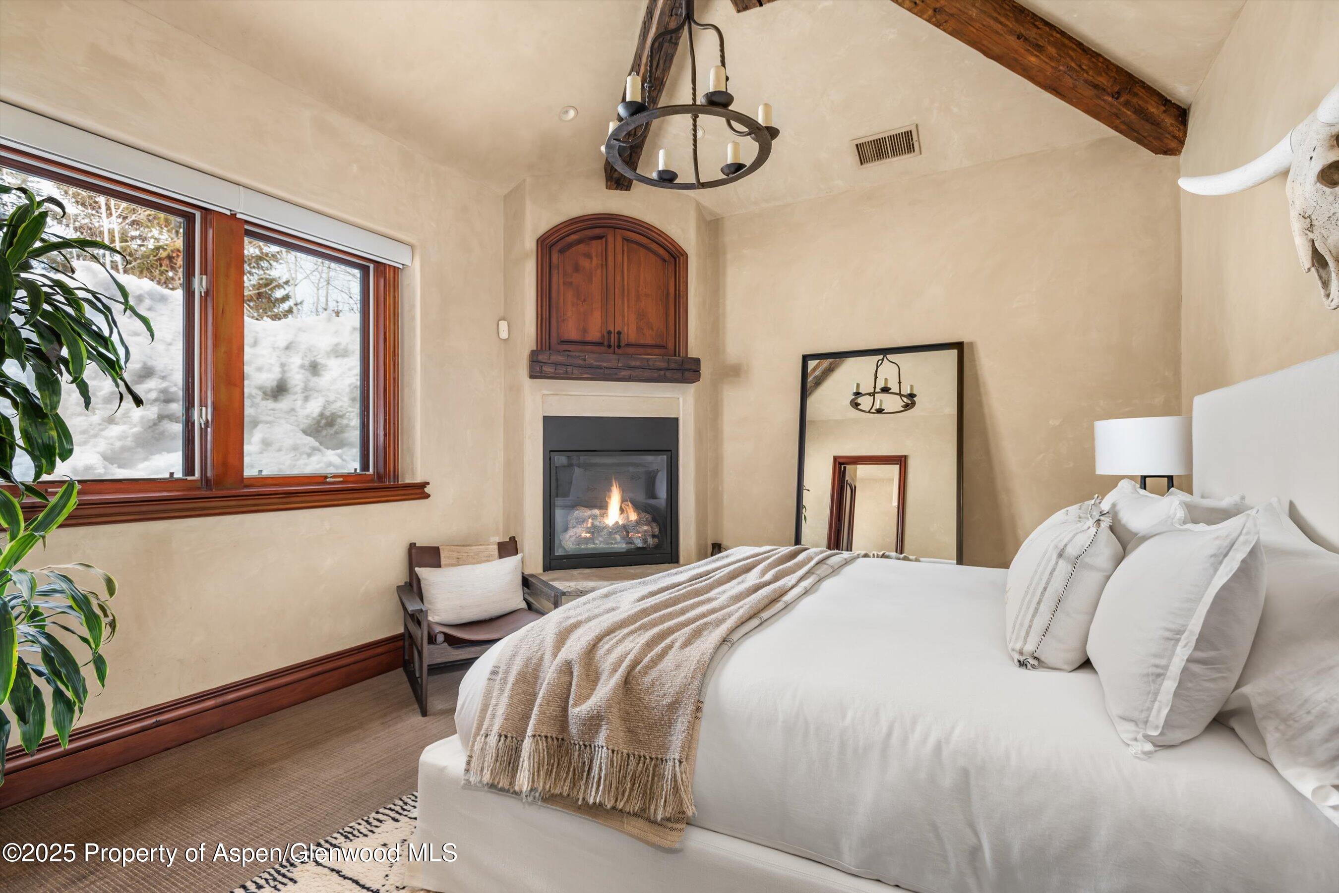 1225 Riverside Drive Aspen, CO 81611 - Photo 41 of 47 a bedroom with a bed and a fireplace