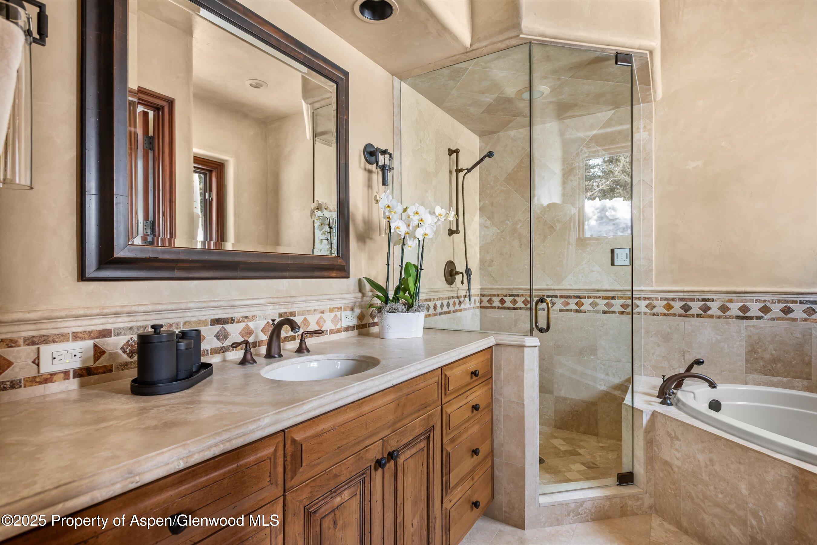 1225 Riverside Drive Aspen, CO 81611 - Photo 42 of 47 a bathroom with a double vanity sink a mirror and bathtub