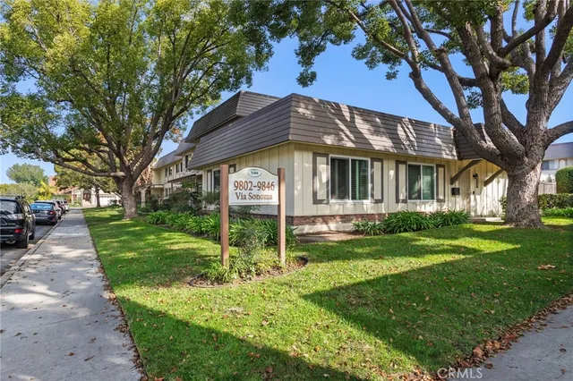a house that has a tree in front of it