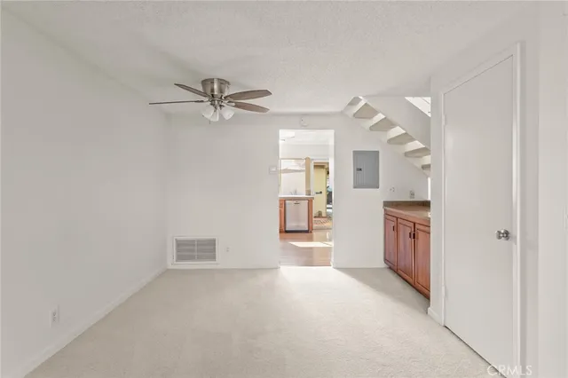 a view of a kitchen with a sink and a refrigerator