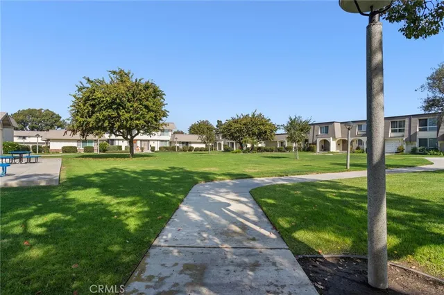 a backyard of a house with lots of green space and garden
