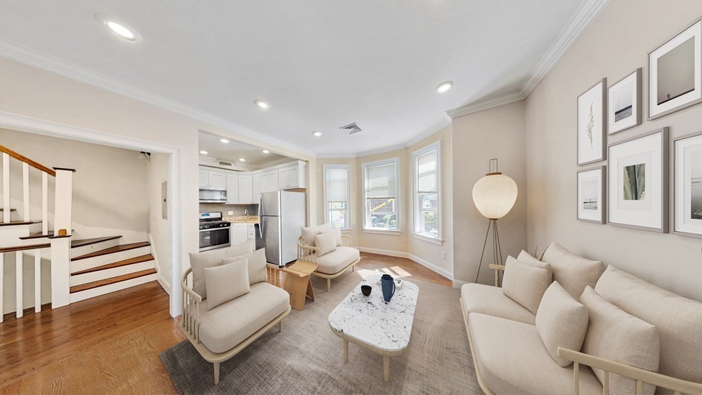 19 Perrin Street, Unit 2 Boston, MA 02119 - Photo 2 of 9 a living room with furniture kitchen view and a wooden floor