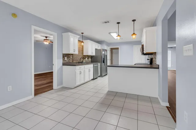 a kitchen with stainless steel appliances a refrigerator and a stove