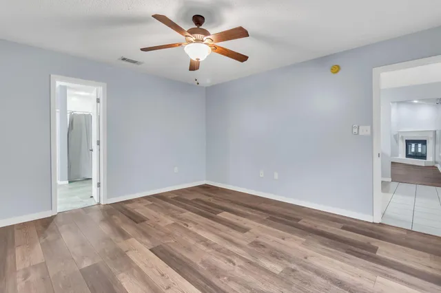 an empty room with fan and a ceiling fan