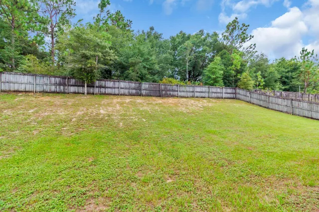 a view of a swimming pool with an outdoor seating and a yard