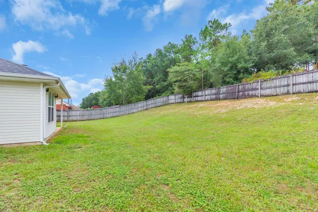 a view of a swimming pool with a yard