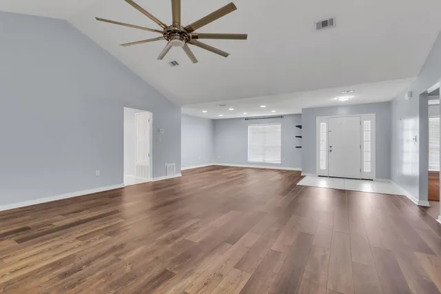 a view of a livingroom with a ceiling fan and wooden floor