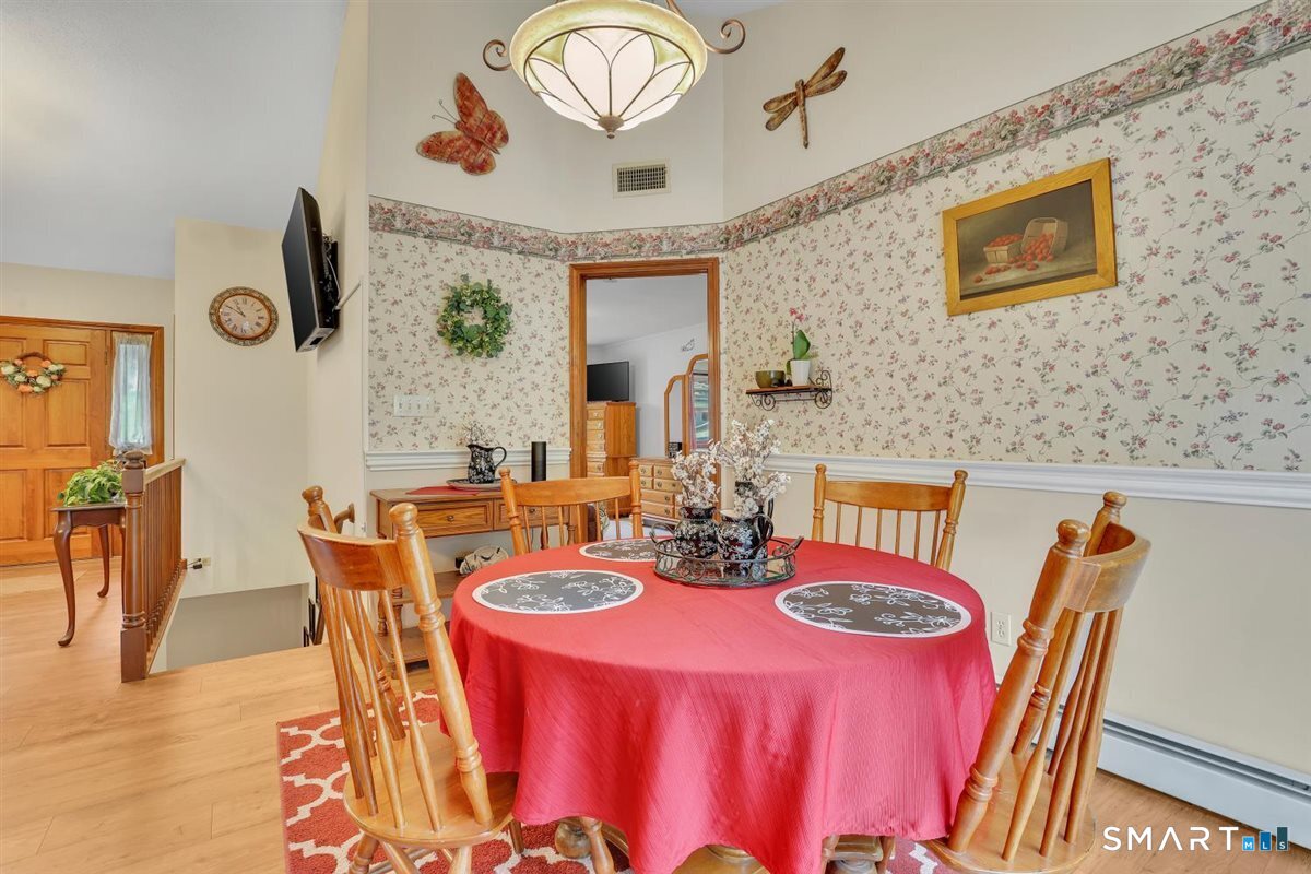 197 Dana Lane Meriden, CT 06451 - Photo 11 of 35 a dining room with furniture a rug and wooden floor