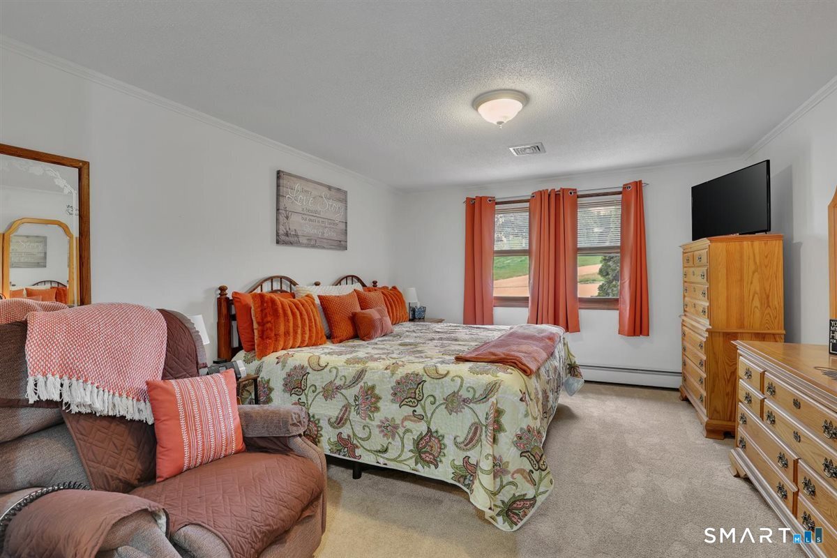 197 Dana Lane Meriden, CT 06451 - Photo 12 of 35 a bedroom with a bed and a flat screen tv