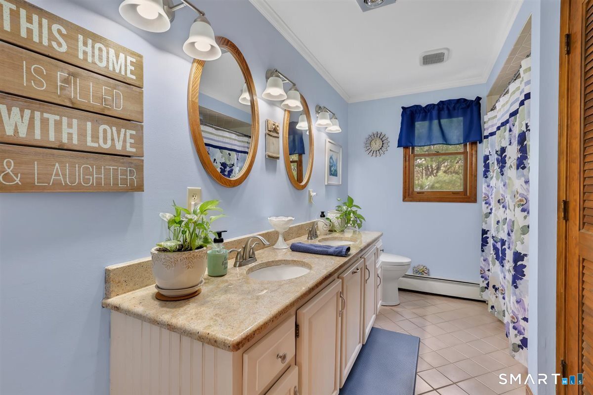 197 Dana Lane Meriden, CT 06451 - Photo 18 of 35 a hallway with painting on the wall and a potted plant