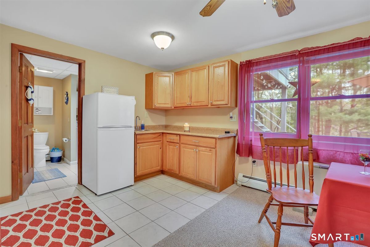 197 Dana Lane Meriden, CT 06451 - Photo 20 of 35 a kitchen with a refrigerator a sink dishwasher and wooden cabinets