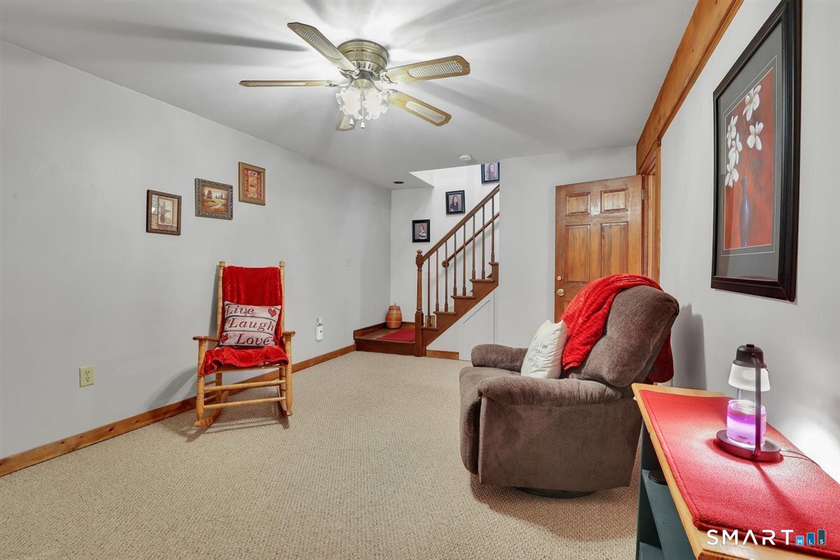 197 Dana Lane Meriden, CT 06451 - Photo 21 of 35 a living room with furniture gym equipment and a chandelier
