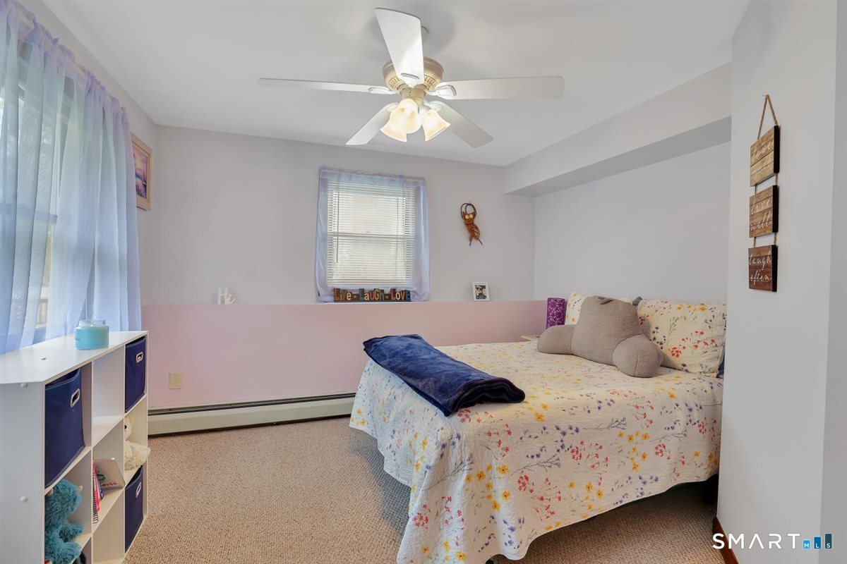 197 Dana Lane Meriden, CT 06451 - Photo 23 of 35 a bedroom with a bed and a chandelier