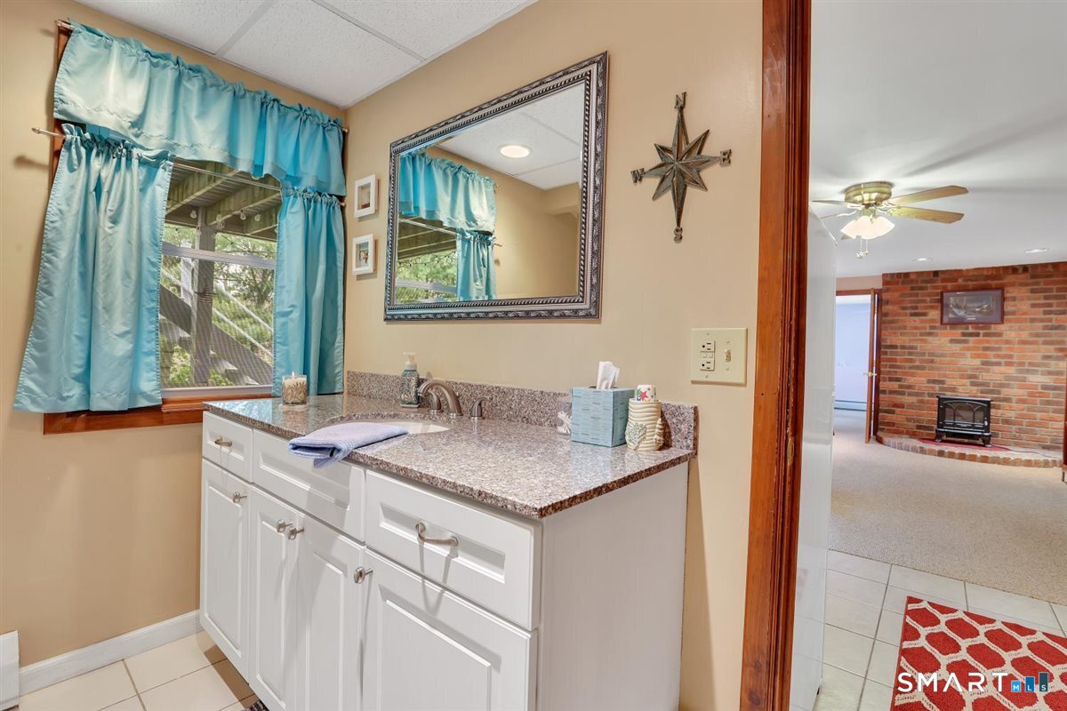 197 Dana Lane Meriden, CT 06451 - Photo 26 of 35 a bathroom with a granite countertop sink mirror and a shower