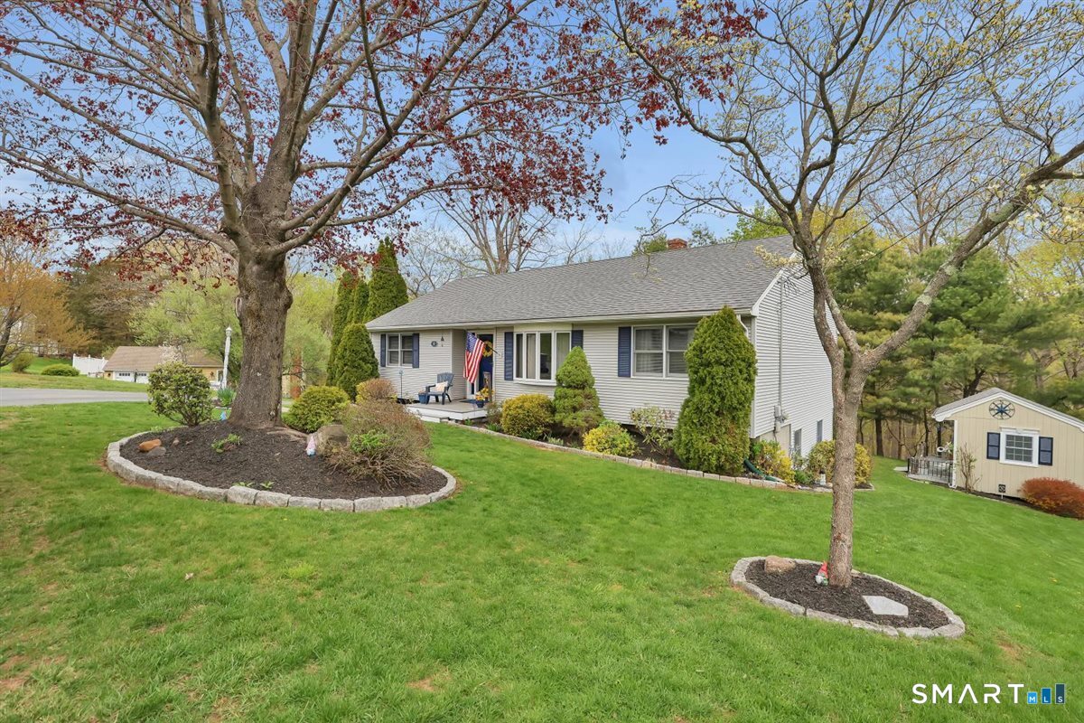197 Dana Lane Meriden, CT 06451 - Photo 3 of 35 a front view of a house with a yard fire pit and large trees