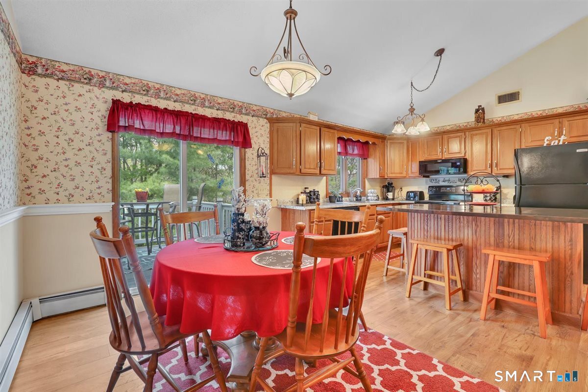197 Dana Lane Meriden, CT 06451 - Photo 10 of 35 a dining room with furniture a chandelier and wooden floor