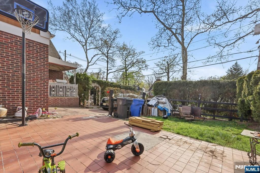 409 Tryon Avenue Englewood, NJ 07631 - Photo 32 of 33 a view of a backyard with a patio