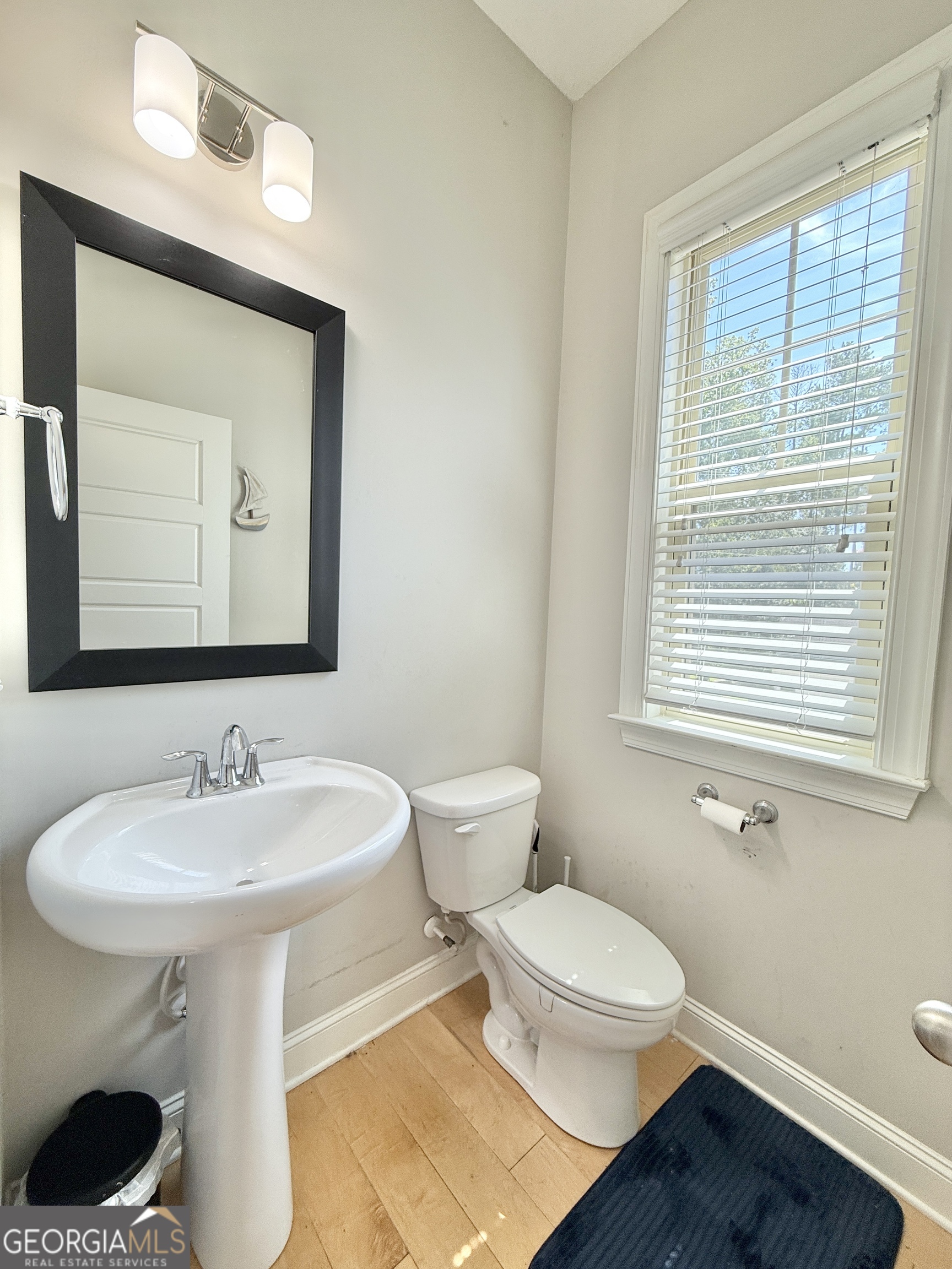 1817 Hislop Lane Atlanta, GA 30345 - Photo 13 of 32 a bathroom with a toilet a sink and a mirror
