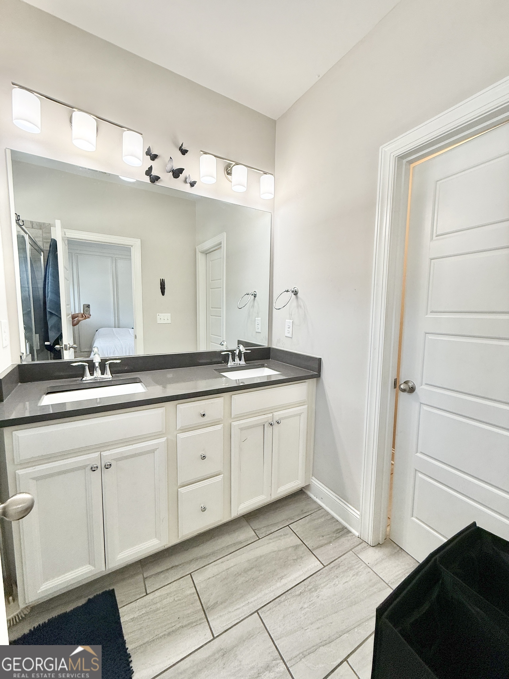 1817 Hislop Lane Atlanta, GA 30345 - Photo 18 of 32 a spacious bathroom with a granite countertop sink and a mirror