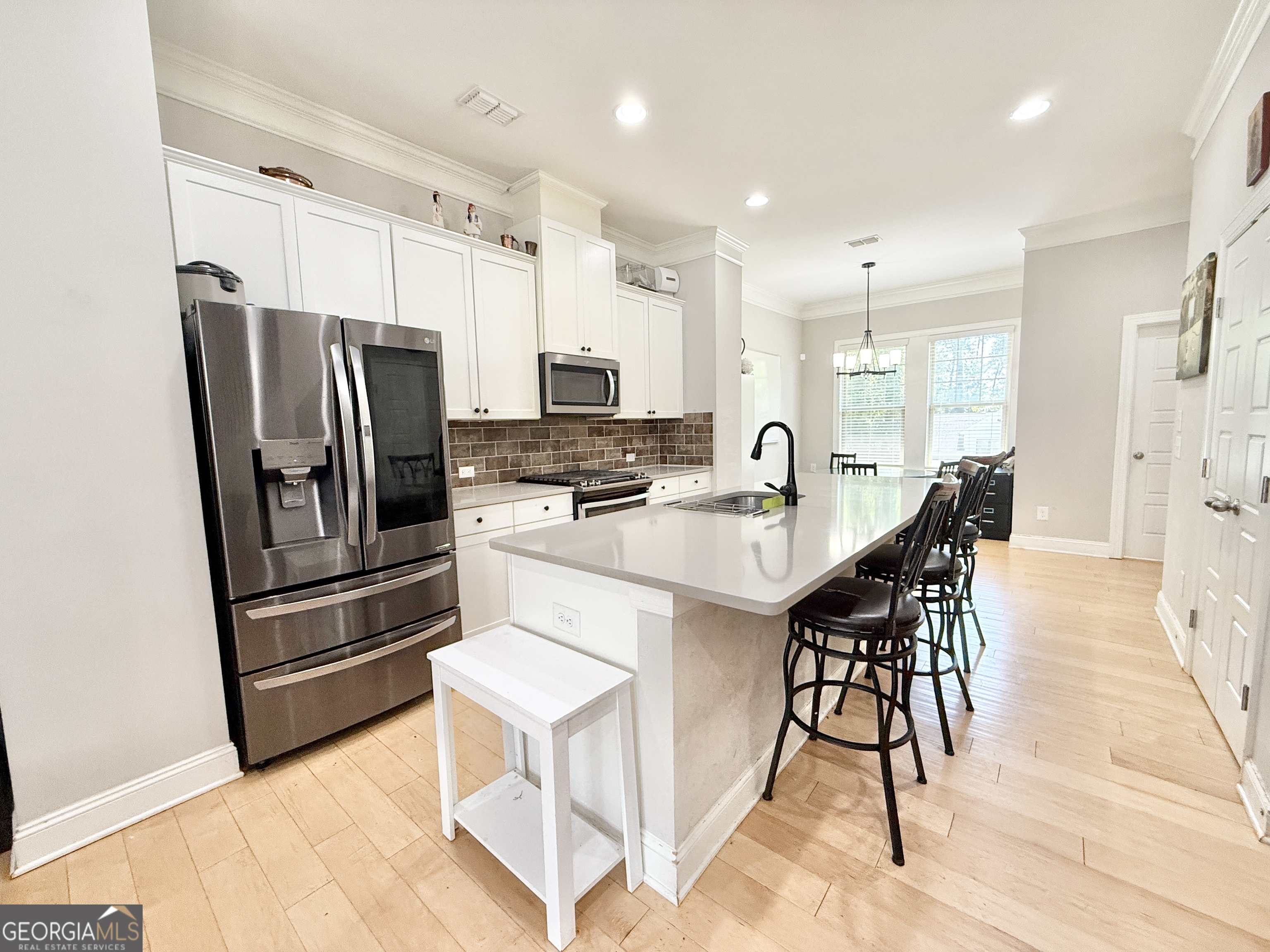 1817 Hislop Lane Atlanta, GA 30345 - Photo 7 of 32 a kitchen with stainless steel appliances kitchen island granite countertop a refrigerator and a stove top oven