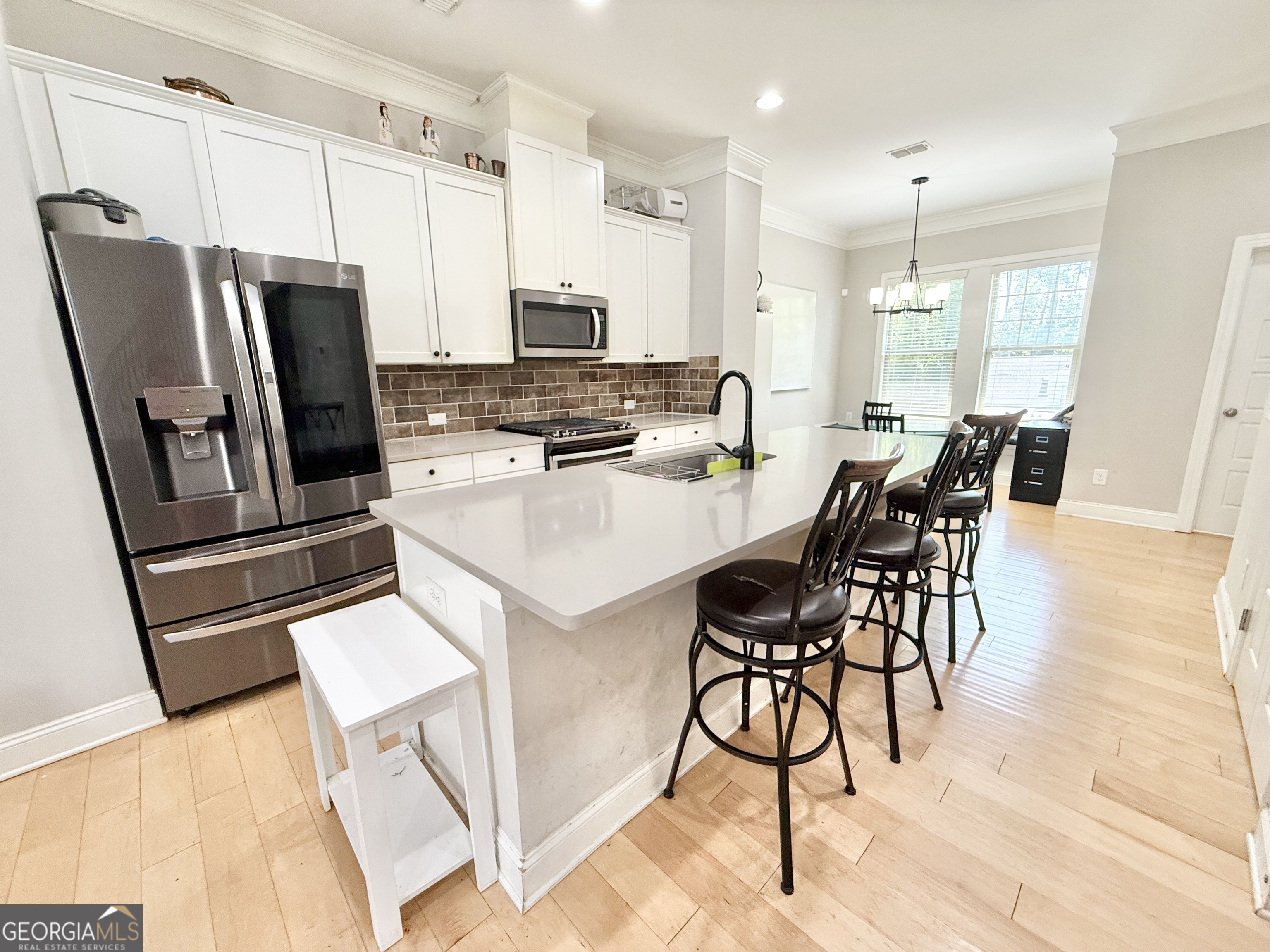1817 Hislop Lane Atlanta, GA 30345 - Photo 8 of 32 a kitchen with stainless steel appliances a stove a refrigerator a sink a dining table and chairs