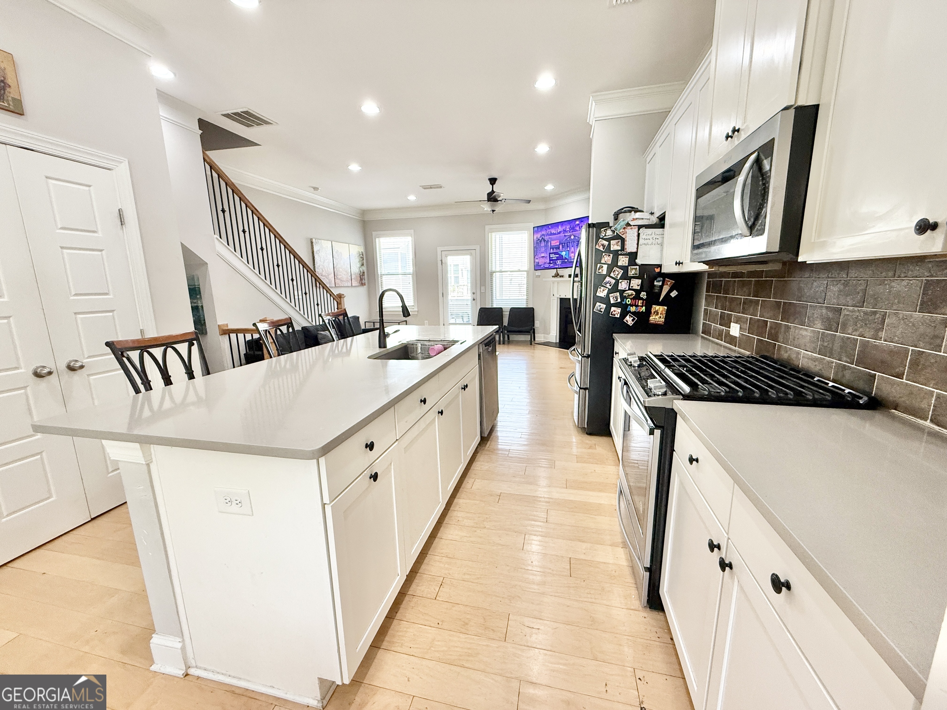1817 Hislop Lane Atlanta, GA 30345 - Photo 10 of 32 a kitchen with counter top space a sink a refrigerator and cabinets