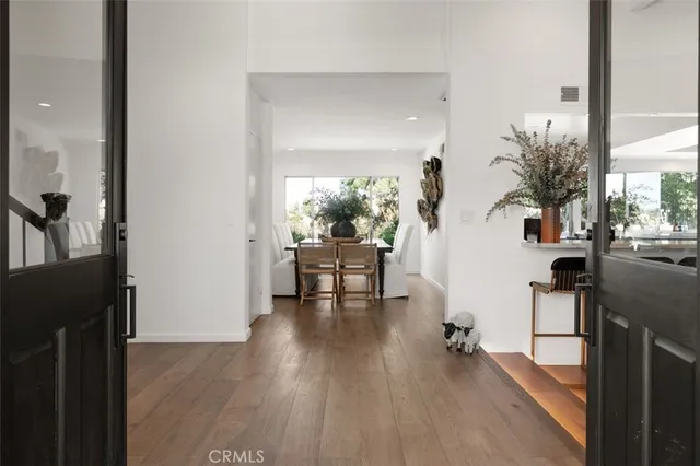 a dining room with furniture and wooden floor