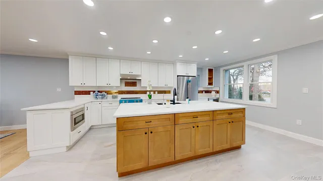 a kitchen with granite countertop white cabinets and white appliances