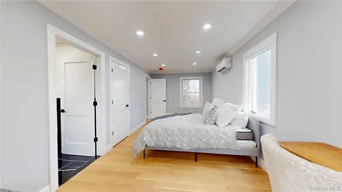 a bedroom with a bed and a couch