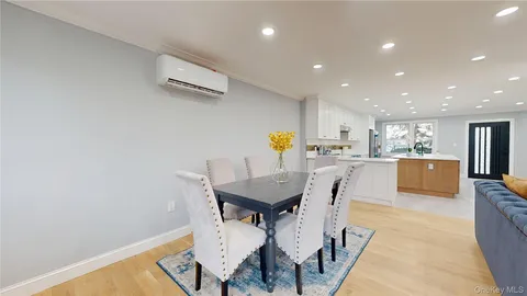 a living room with stainless steel appliances kitchen island granite countertop furniture a rug and a kitchen view