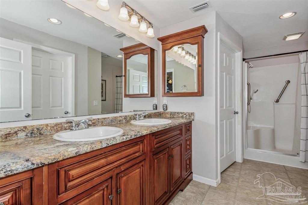 1261 Mahogany Mill Road Pensacola, FL 32507 - Photo 12 of 21 a bathroom with a granite countertop double vanity sink and a mirror
