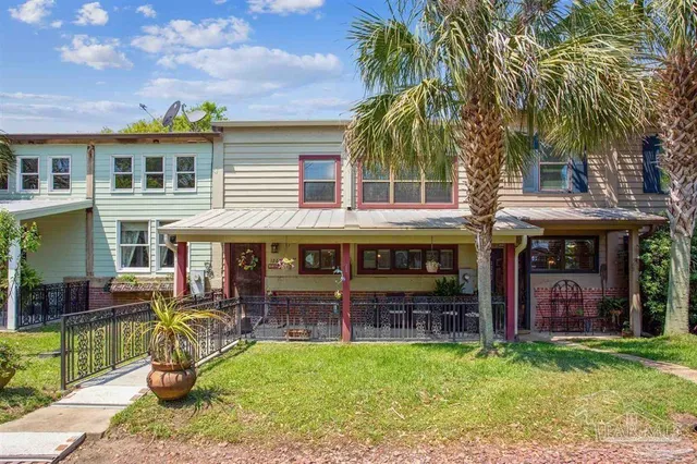 a view of a house with backyard porch and sitting area