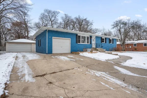 a view of a house with a yard covered in snow