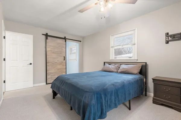 a bedroom with a bed and a chandelier