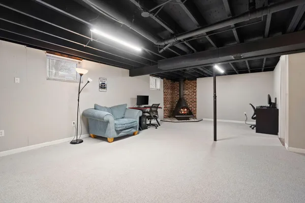 a living room with furniture and a water heater