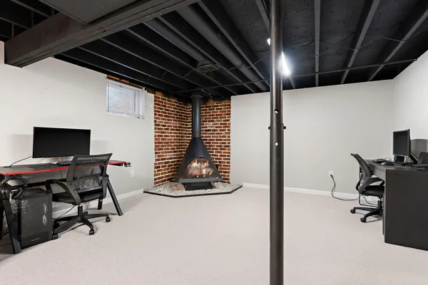 a work room with furniture and a flat screen tv
