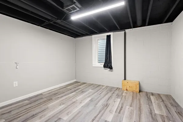 a view of a room with wooden floor