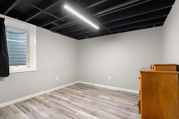 a view of a room with wooden floor