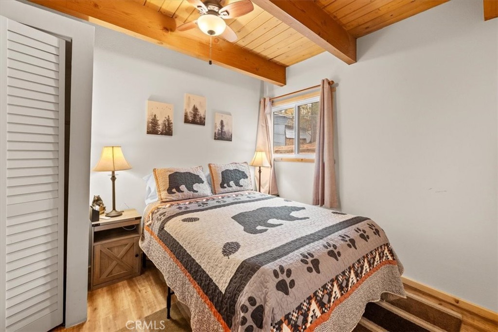 567 Highland Road Big Bear Lake, CA 92315 - Photo 15 of 42 a bedroom with a bed and wooden floor