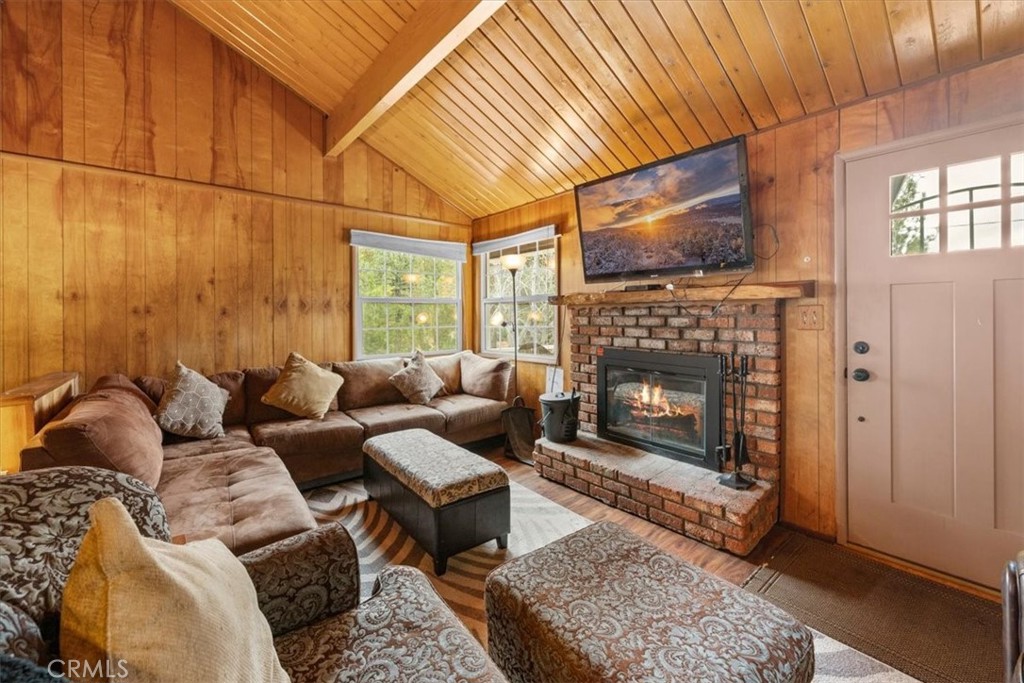 567 Highland Road Big Bear Lake, CA 92315 - Photo 24 of 42 a living room with furniture a flat screen tv and a fireplace