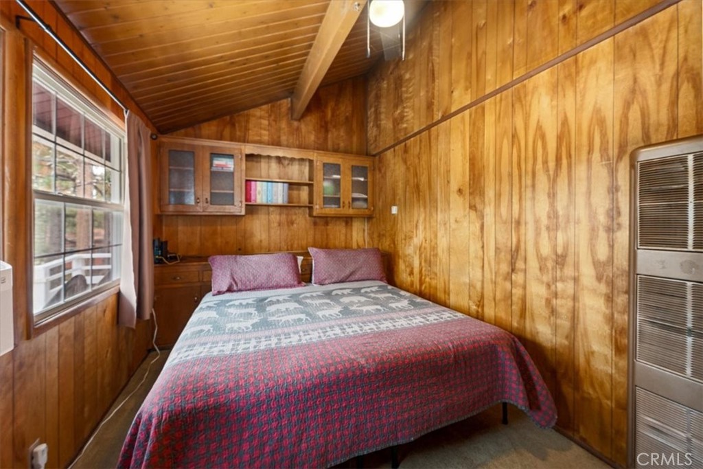 567 Highland Road Big Bear Lake, CA 92315 - Photo 27 of 42 a bedroom with a bed and wooden floor
