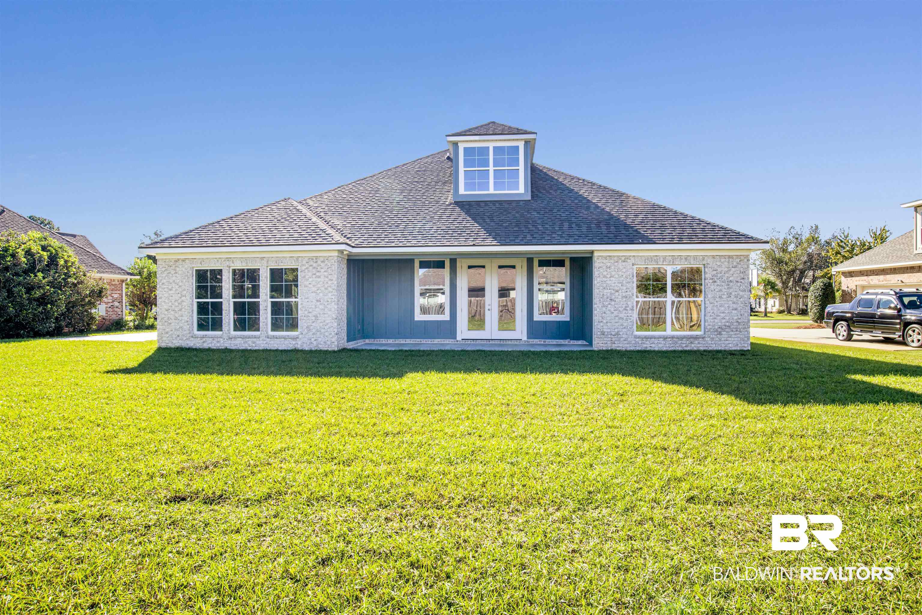 9687 Widgeon Court Daphne, AL 36526 - Photo 35 of 40 Back of property with french doors and a lawn
