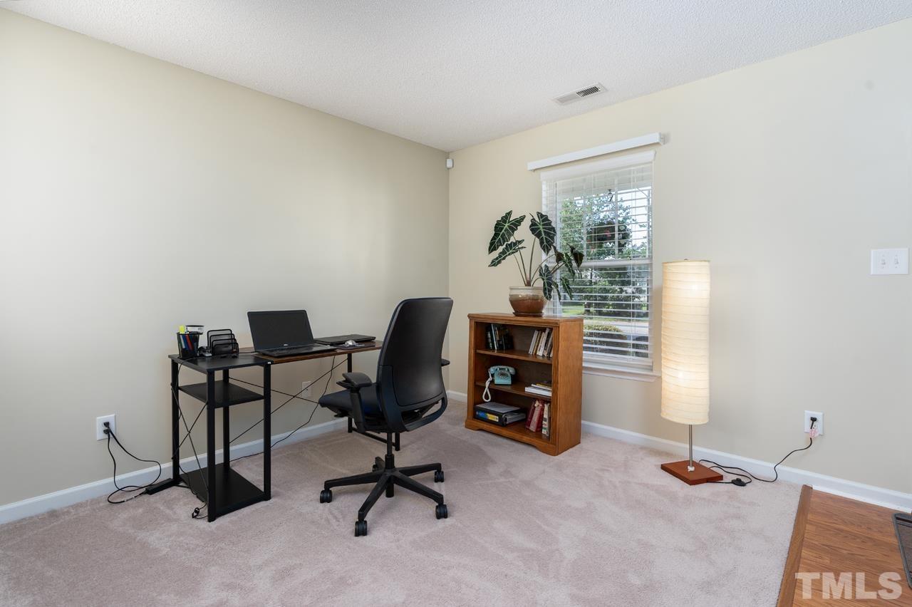 3815 Hopper Street Raleigh, NC 27616 - Photo 3 of 18 a view of a workspace with furniture and a window